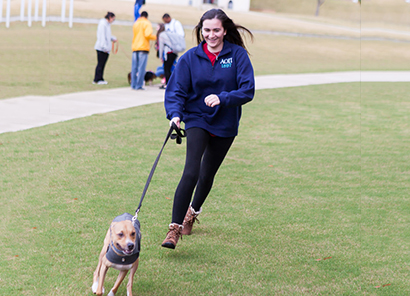 girl running with dog