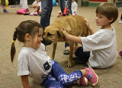 kids playing with dog