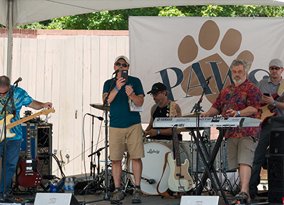 man singing Paws event